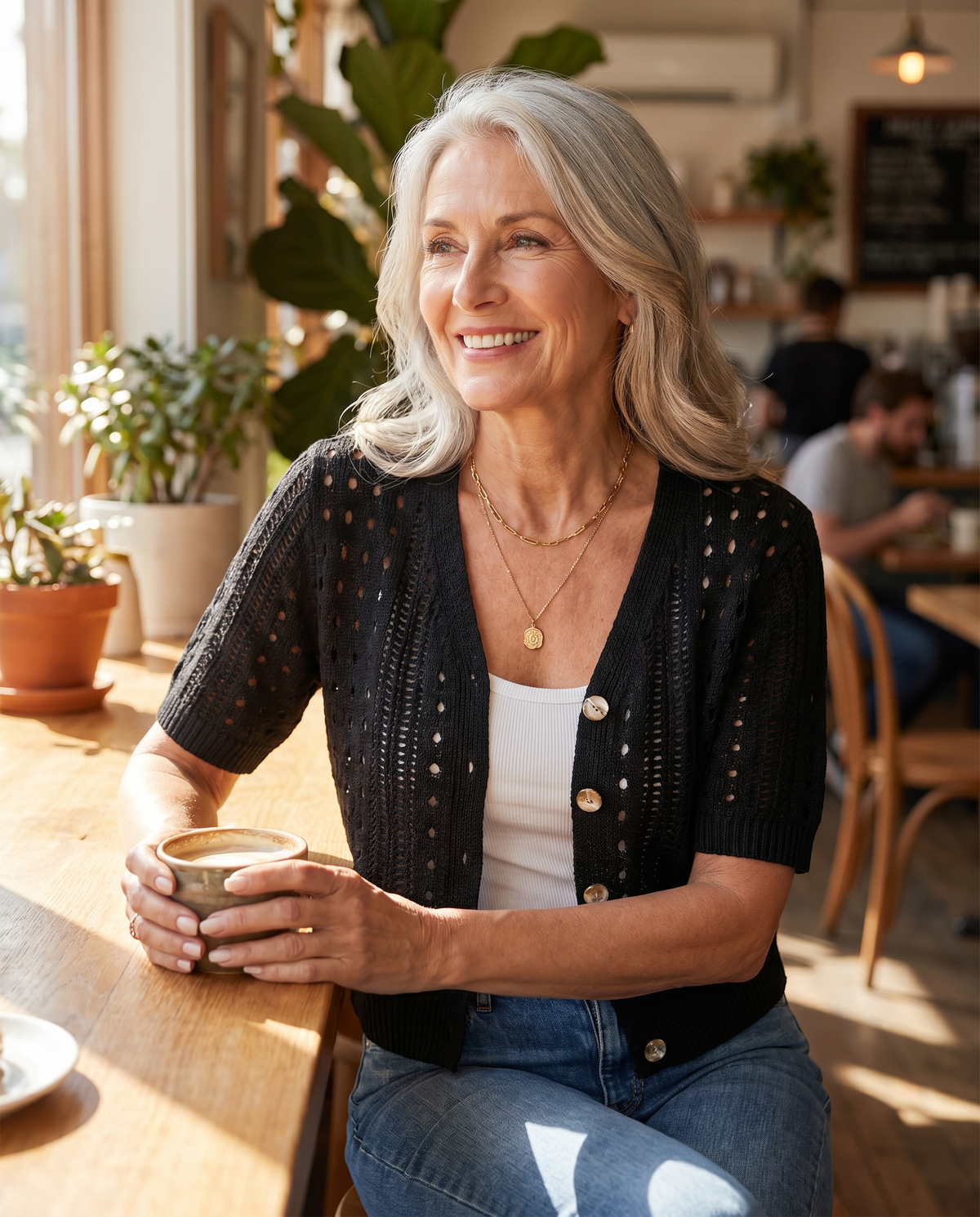 Black women's short-sleeve knit cardigan styled casually at a café, summer outfit